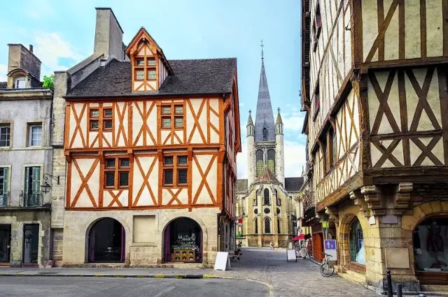 Die Kirche Notre-Dame de Dijon und Fachwerkhäuser in der Altstadt von Dijon in der französischen Region Burgund.