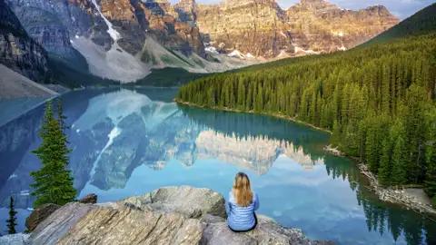 Fast unwirklich strahlt das Wasser des von Berggipfeln gesäumten Moraine Lake. Immer im Blick: die zerklüftete Berglandschaft der Rocky Mountains.