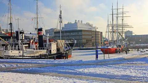 Auf Ihrer Gruppenreise nach Bremen sehen wir Historische Schiffe im Winter im verschneiten Hafen.