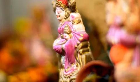 Figur einer Hindu-Göttin, die mit traditioneller Kleidung und Schmuck dargestellt ist.