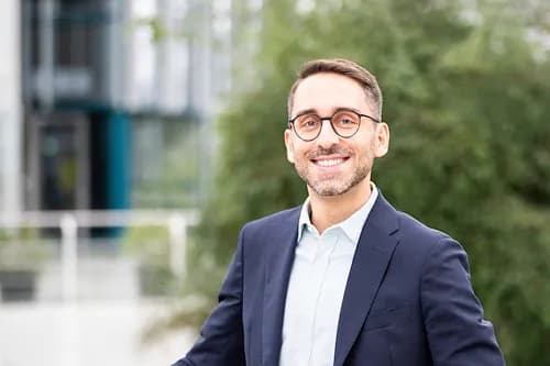 Tony Reyhanloo, Head of Corporate Responsibility bei der Unternehmensgruppe Studiosus, lächelt in die Kamera.