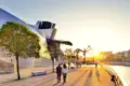 Auf unserer Städtereise CityLights Bilbao erleben Sie in kleiner Gruppe und mit Studiosus-Reiseleitung die Höhepunkte der Stadt, beispielsweise das Guggenheim-Museum mit der Skulptur "Maman" bei Sonnenuntergang.