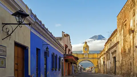 Erleben Sie auf der Studiosus-Reise nach Guatemala die koloniale Pracht Antiguas: kopfsteingepflasterte Straßen, farbenfrohe Fassaden und eindrucksvolle Kirchen und Klöster vor der Kulisse der gewaltigen Vulkane Agua, Fuego und Acatenango.