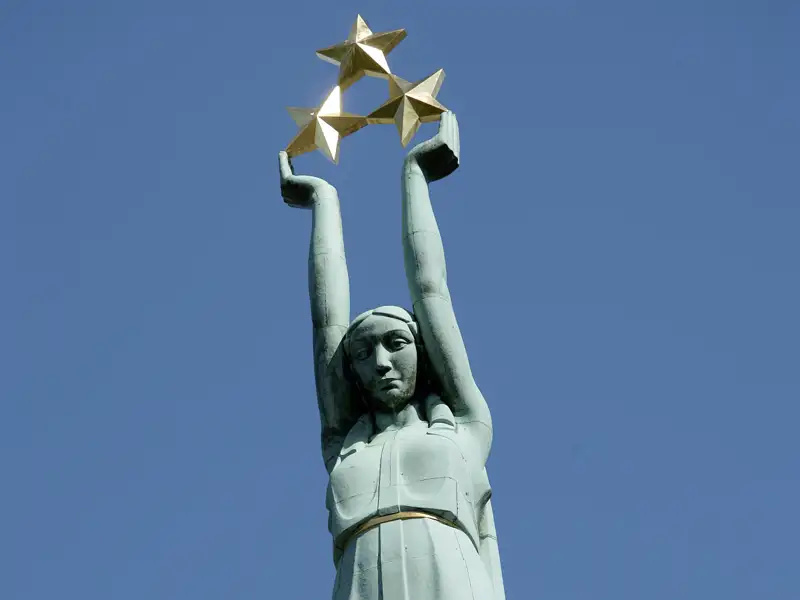 Die neun Meter hohe Freiheitsstatue bekrönt das Freiheitsdenkmal in Riga, Lettlands Hauptstadt. Die drei Sterne in ihren Händen symbolisieren die drei historischen Regionen Lettlands.