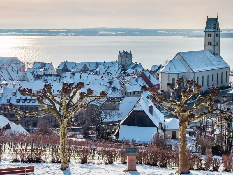 Blick auf das verschneite Meersburg, den Bodensee und den Alpenrand