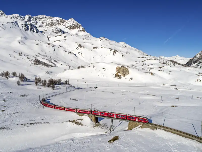 Auf unserer Gruppenreise darf natürlich eine Fahrt mit dem berühmten Bernina Express nicht fehlen! Auf unserer Fahrt mit dem Zug bestauenen wir aus dem Fenster die verschneiten Landschaften