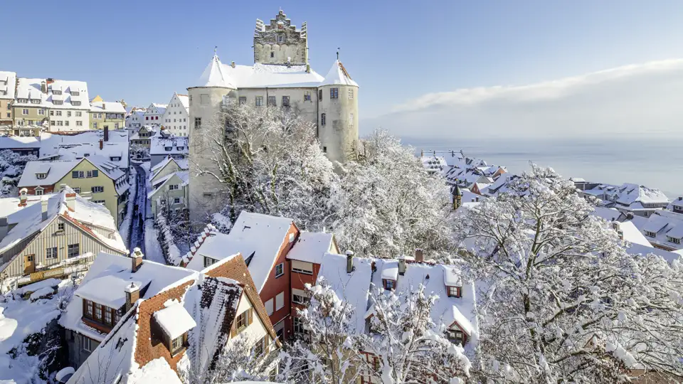 Die schneebedeckte Burg Meersburg thront über den Dächern der Altstadt mit Blick auf den winterlichen Bodensee. Ein Highlight während Ihrer Eventreise.